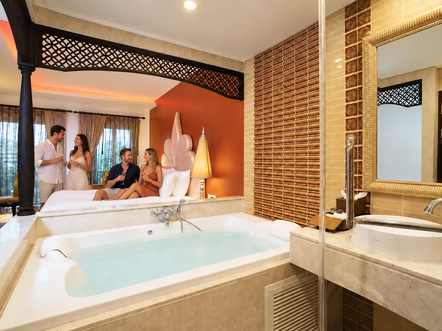 Two tourist couples in the actual Chillax Resort Deluxe room beside the private whirlpool